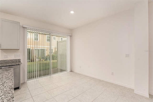 spare room featuring light tile patterned flooring