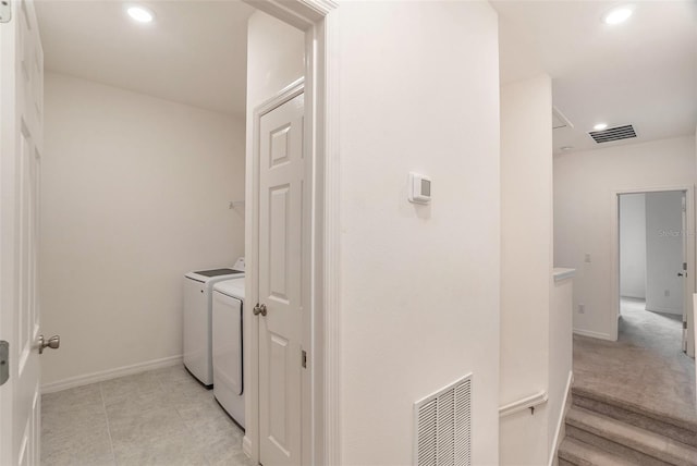 laundry area with light tile patterned floors and separate washer and dryer