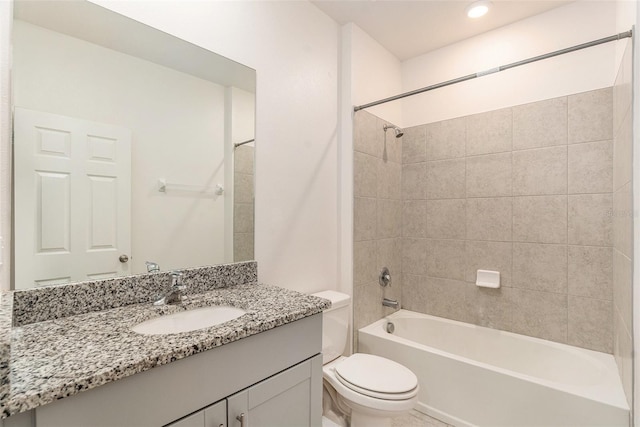 full bathroom featuring toilet, vanity, and tiled shower / bath