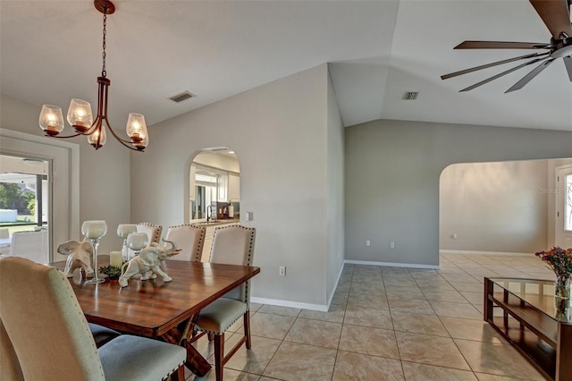 tiled dining area with ceiling fan with notable chandelier, lofted ceiling, and sink