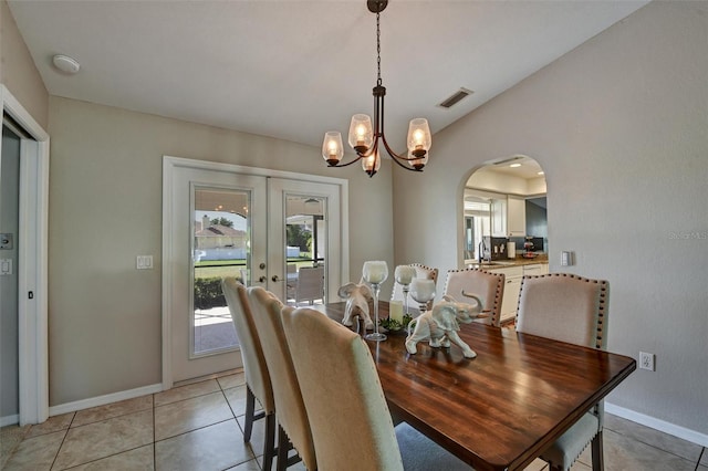 tiled dining area featuring french doors, an inviting chandelier, and sink