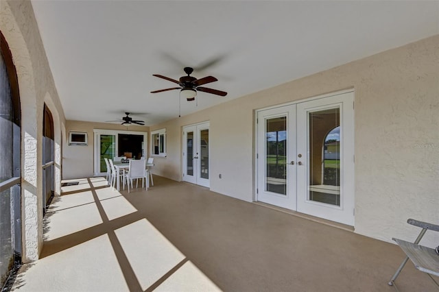 unfurnished sunroom with french doors and ceiling fan