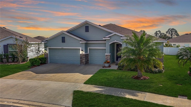 view of front facade with a yard and a garage