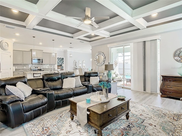 living room with beam ceiling, ceiling fan, coffered ceiling, crown molding, and light hardwood / wood-style floors