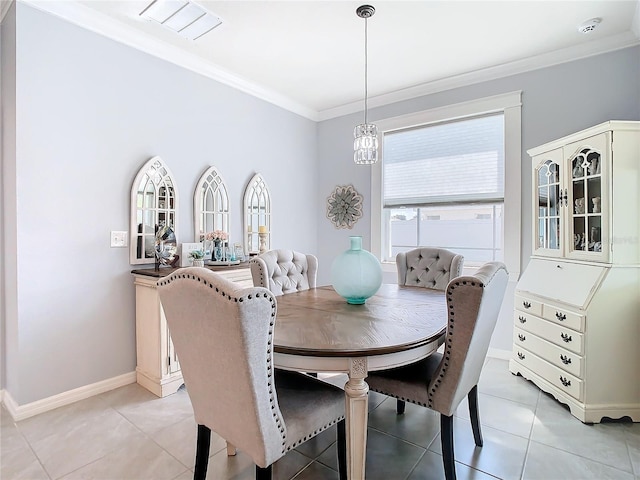 dining room with light tile patterned flooring and crown molding