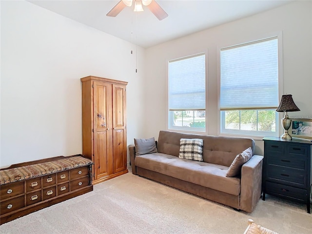 living room featuring ceiling fan and light colored carpet