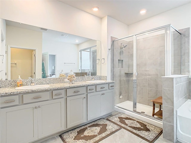 bathroom with vanity and a shower with door