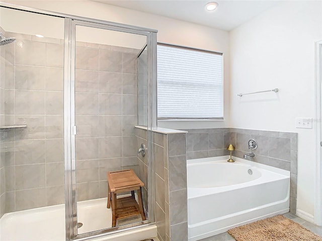 bathroom with shower with separate bathtub