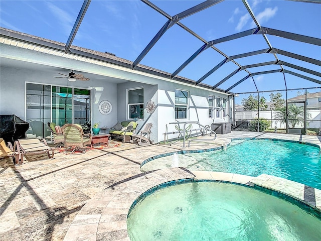 view of pool with glass enclosure, ceiling fan, and a patio