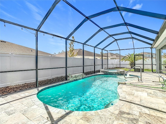 view of swimming pool with a lanai, an in ground hot tub, and a patio