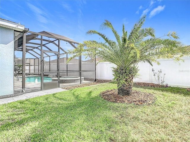 view of yard with a swimming pool with hot tub and glass enclosure