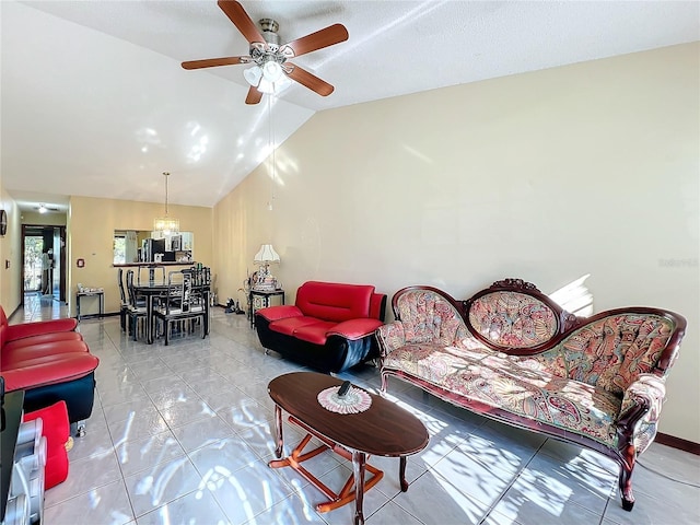 living room with tile patterned flooring, ceiling fan with notable chandelier, and lofted ceiling