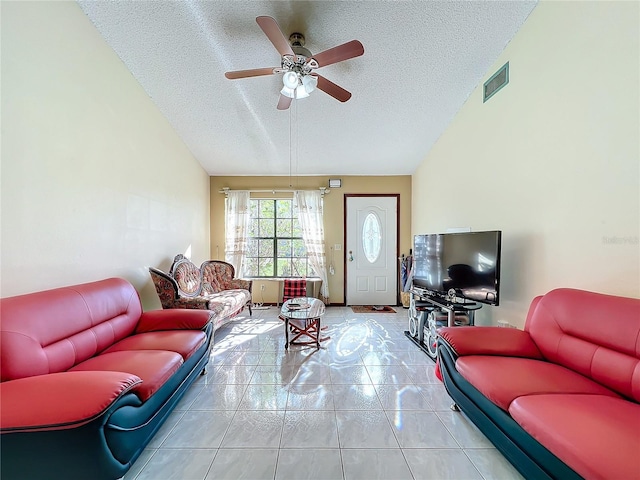 tiled living room featuring a textured ceiling and ceiling fan