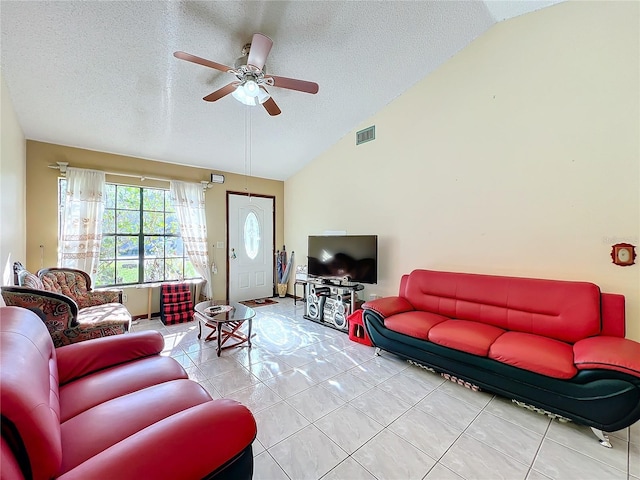 tiled living room featuring a textured ceiling, ceiling fan, and lofted ceiling