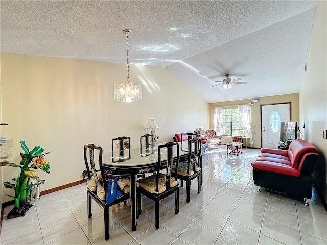 tiled dining area with ceiling fan with notable chandelier, lofted ceiling, and a textured ceiling