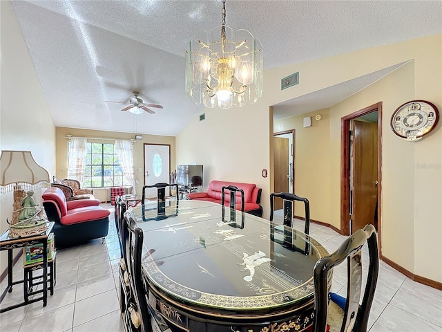 dining area featuring ceiling fan with notable chandelier, light tile patterned floors, a textured ceiling, and vaulted ceiling