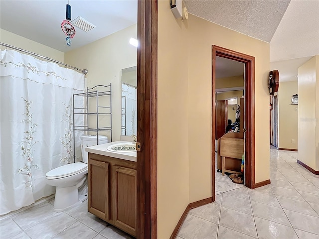 bathroom featuring a shower with curtain, a textured ceiling, vanity, tile patterned flooring, and toilet