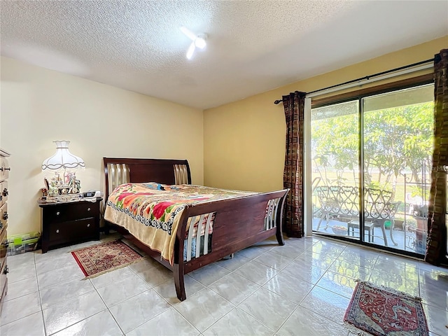 tiled bedroom with access to exterior and a textured ceiling