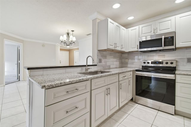 kitchen with an inviting chandelier, white cabinets, sink, crown molding, and appliances with stainless steel finishes