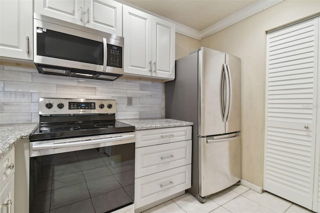 kitchen with white cabinetry, stainless steel appliances, and backsplash