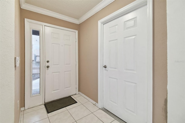 tiled entryway featuring a textured ceiling and ornamental molding