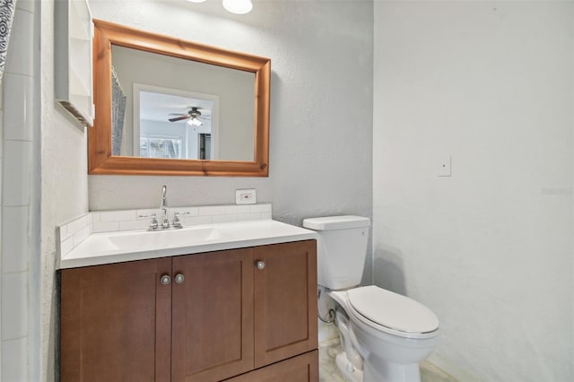 bathroom featuring ceiling fan, vanity, and toilet