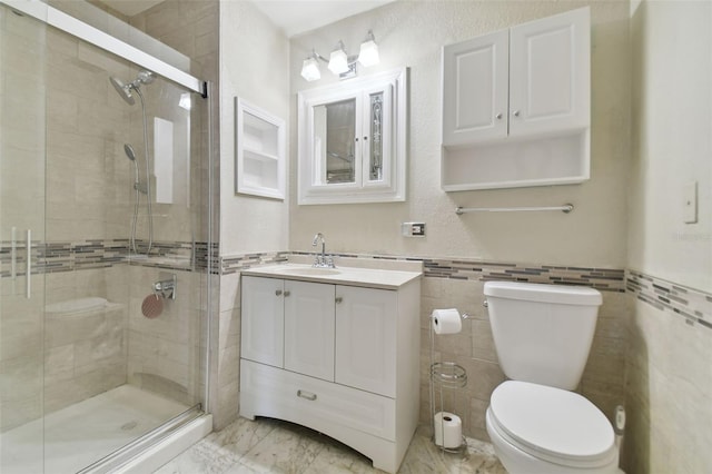 bathroom with walk in shower, vanity, toilet, and tile walls