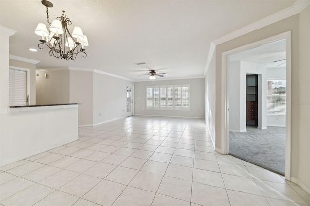 carpeted spare room with ceiling fan with notable chandelier, a wealth of natural light, and crown molding