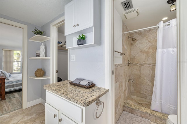 bathroom featuring toilet, a textured ceiling, tile patterned floors, and curtained shower