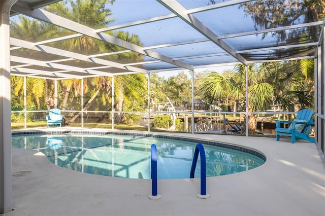 view of pool with a patio area and a lanai