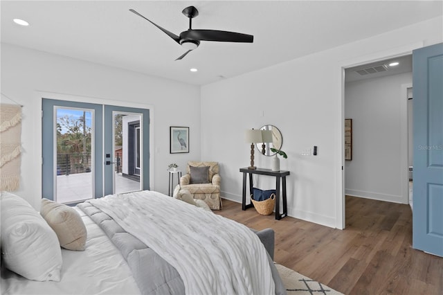 bedroom with dark wood-type flooring, access to outside, french doors, and recessed lighting