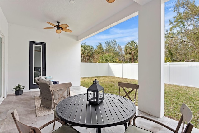 view of patio / terrace featuring a fenced backyard, outdoor dining area, and a ceiling fan