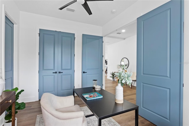 office space featuring visible vents, ceiling fan, and wood finished floors