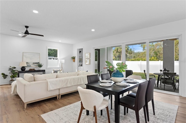 dining space with light wood finished floors, a wealth of natural light, and recessed lighting