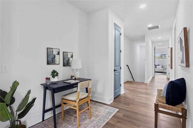 office with baseboards, visible vents, wood finished floors, and recessed lighting