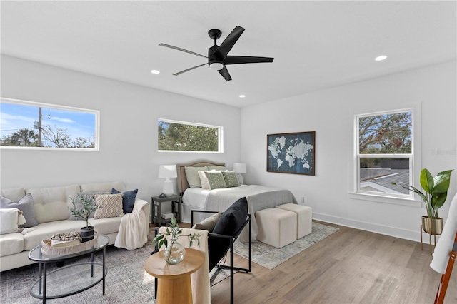 bedroom featuring a ceiling fan, baseboards, wood finished floors, and recessed lighting