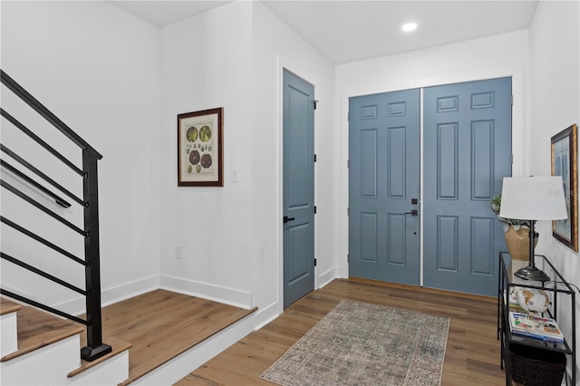 entryway featuring stairs, recessed lighting, wood finished floors, and baseboards