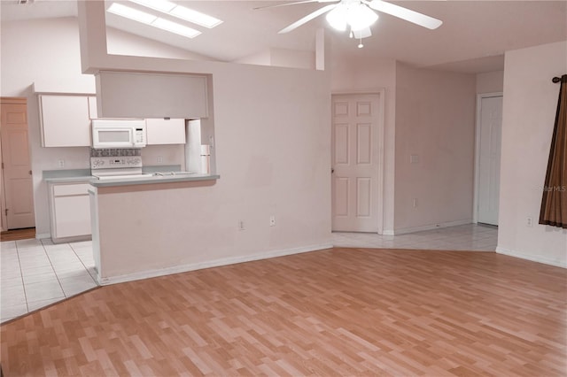 unfurnished living room featuring light hardwood / wood-style floors, vaulted ceiling, and ceiling fan