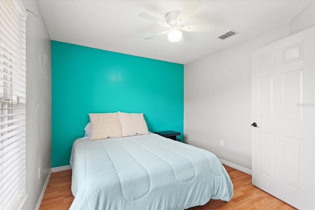 bedroom featuring light hardwood / wood-style floors and ceiling fan