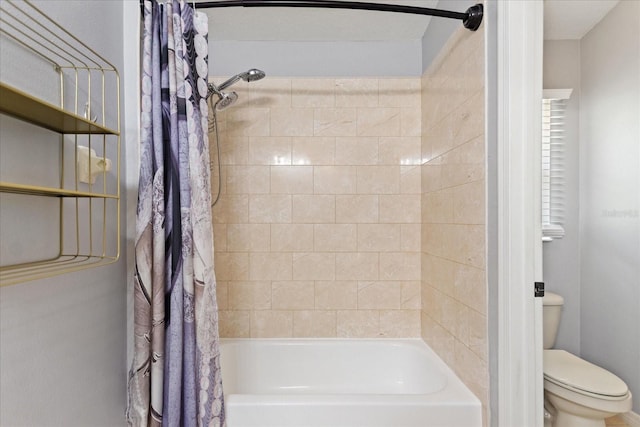 bathroom featuring shower / bath combo and toilet