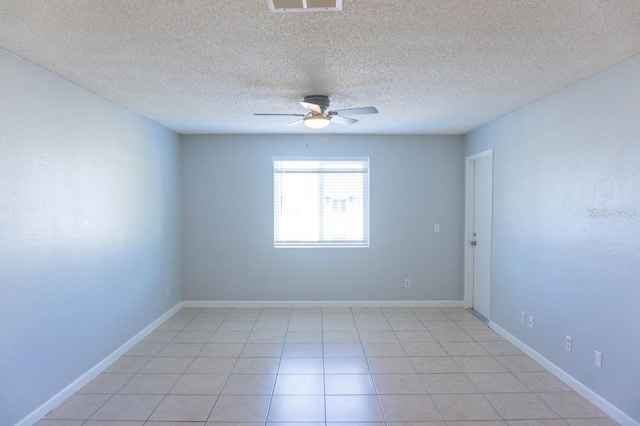 unfurnished room featuring a textured ceiling, ceiling fan, and light tile patterned flooring