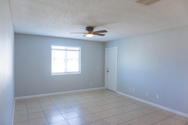 tiled empty room with a textured ceiling and ceiling fan