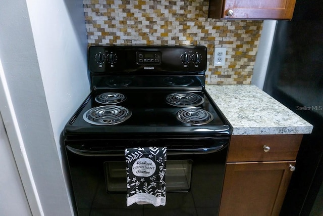 kitchen with tasteful backsplash and electric range