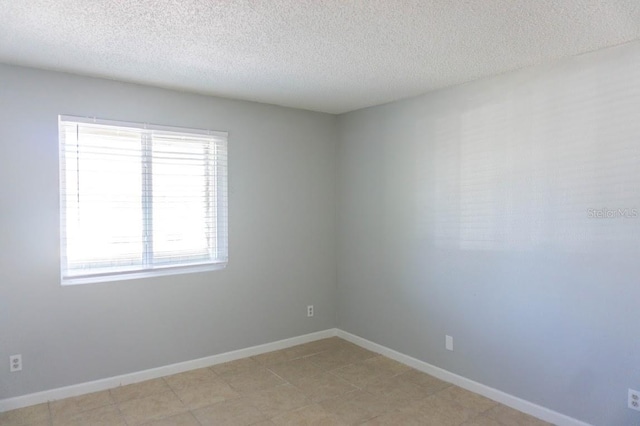 spare room with a textured ceiling