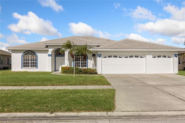 view of front of home with a front lawn and a garage