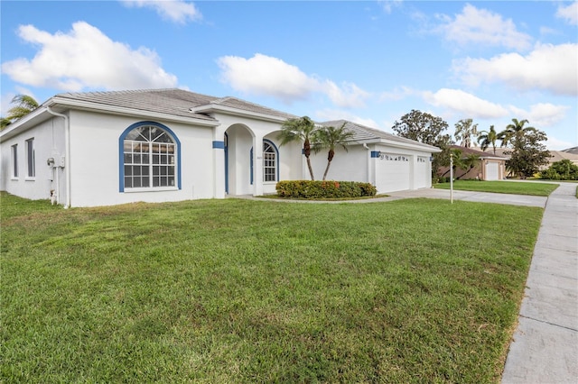 view of front of property with driveway, stucco siding, a garage, and a front yard