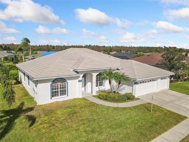 view of front of property with a garage, driveway, a front yard, and a tiled roof