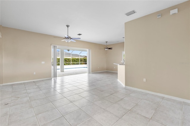 tiled empty room featuring ceiling fan