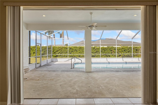 doorway to outside featuring tile patterned flooring and ceiling fan