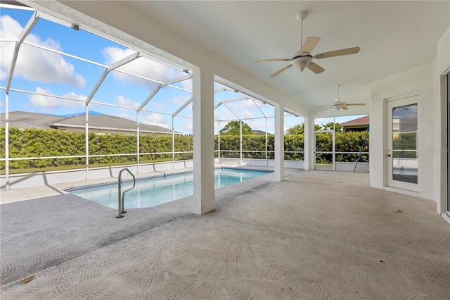 view of swimming pool featuring a lanai, ceiling fan, and a patio